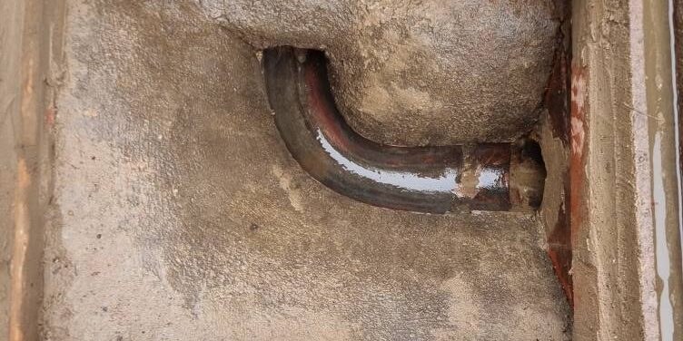 Drain inspection showing a cleanout pipe in a commercial drainage system.