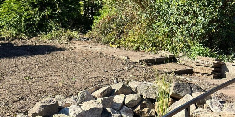 Blocked drain under pond repair by Drain 2 Drain Ltd, ensuring proper water flow and preventing floo.