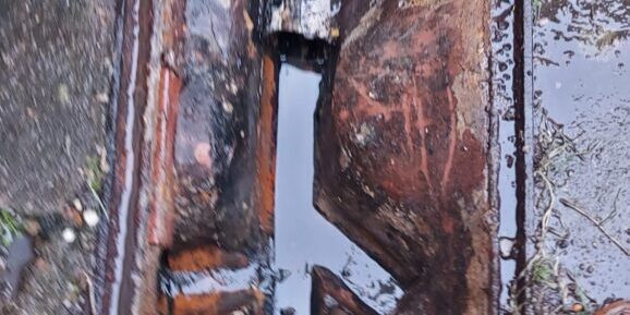 Blocked drain with visible damage and debris, repaired quickly by professional drain specialists.