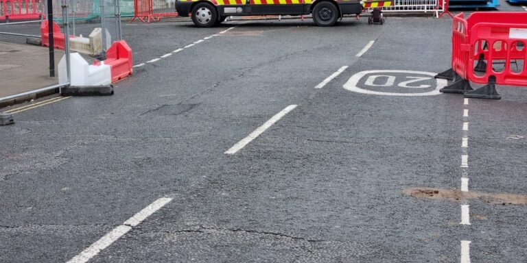 Drain 2 Drain Ltd van working on road drainage repair and maintenance. Professional drainage service.