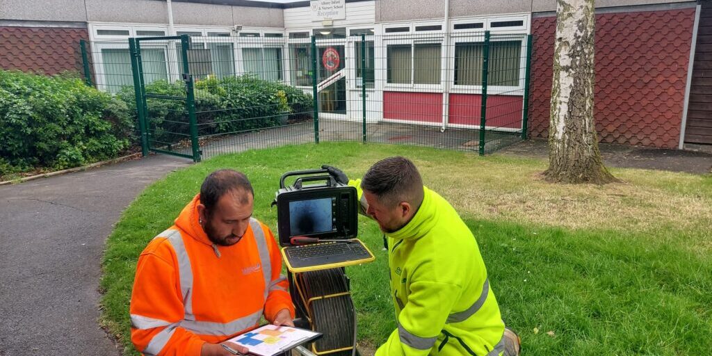 Drainage engineers inspecting school drainage system in Nottingham.
