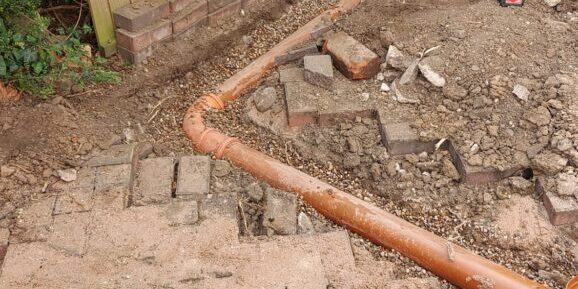 Redirecting drainage from an inactive Victorian tank for improved flow and safety.