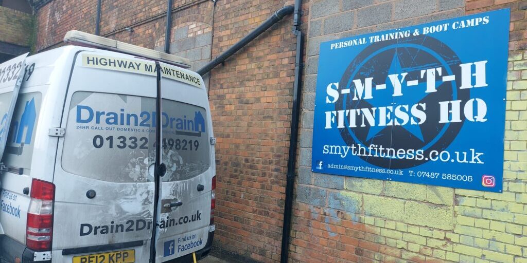 Drain cleaning service outside a gym in Loughborough for blocked drains.